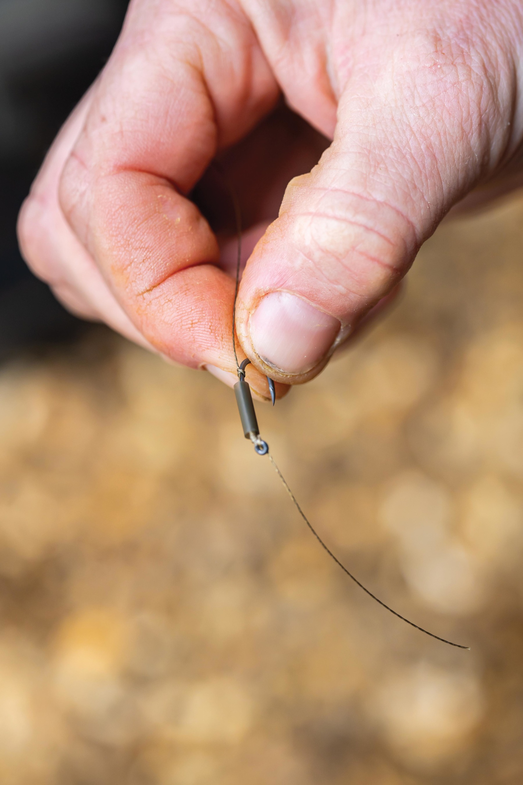 Take a piece of medium shrink tube and slide it over the hook. 